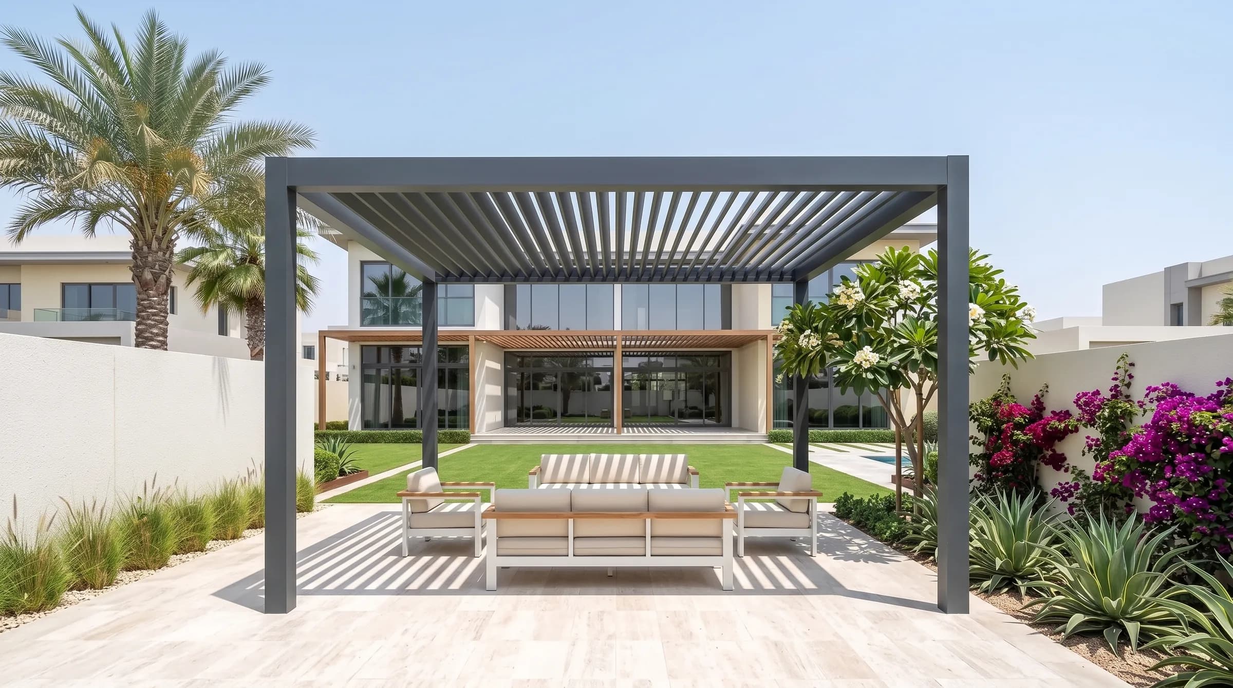 Pergolas and shade hero: a modern aluminium louvred pergola casting slat shadows over an outdoor lounge on a villa terrace